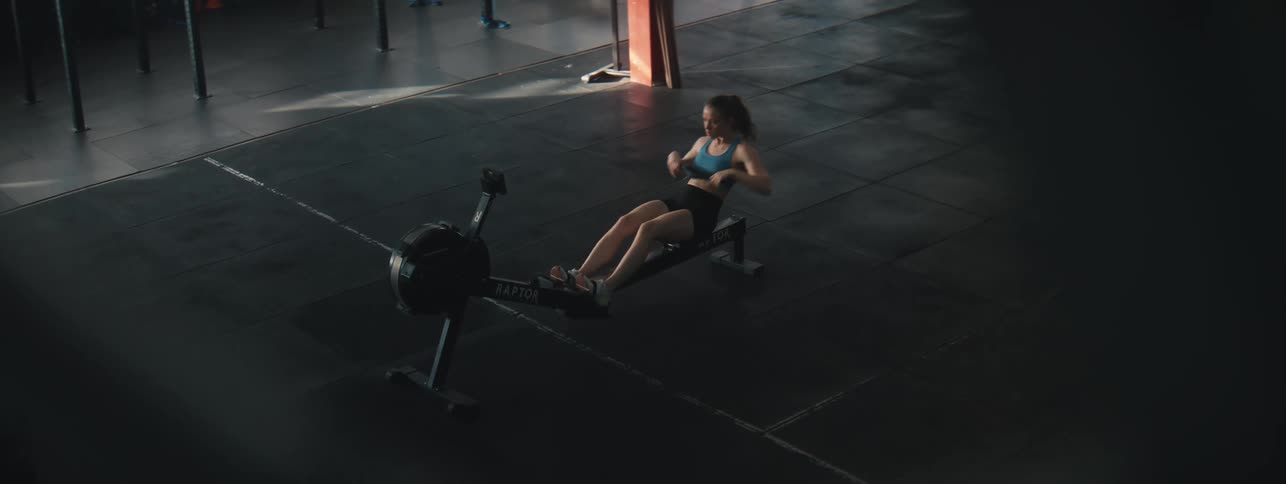 Woman warming up on an ergonomic machine at a gym