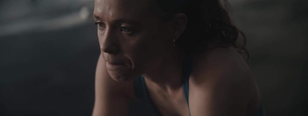 Woman with sweaty face taking deep breaths