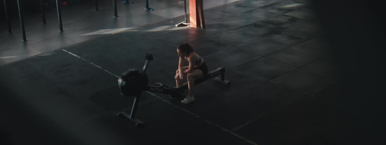 Woman sitting on a cardio machine in a gym
