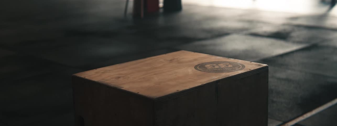 A person jumps on the wooden box