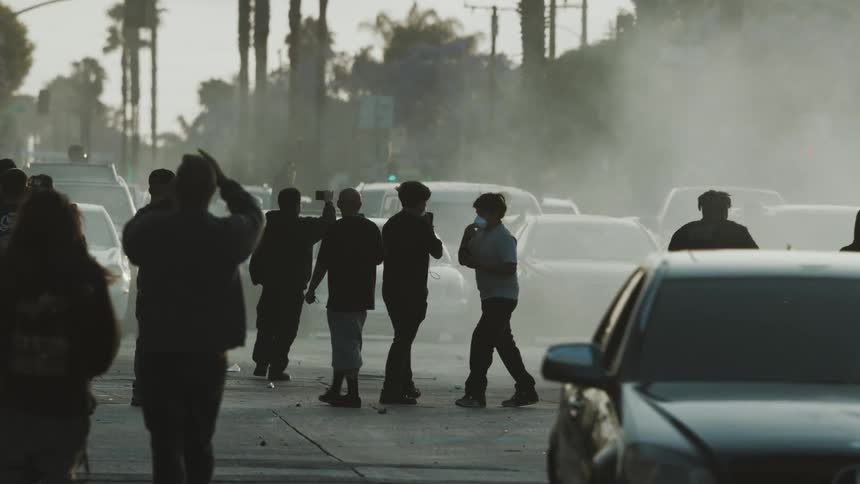 Protesters are walking on the smoke filled road