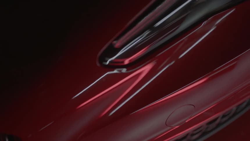 Light is reflecting off a shiny red surface