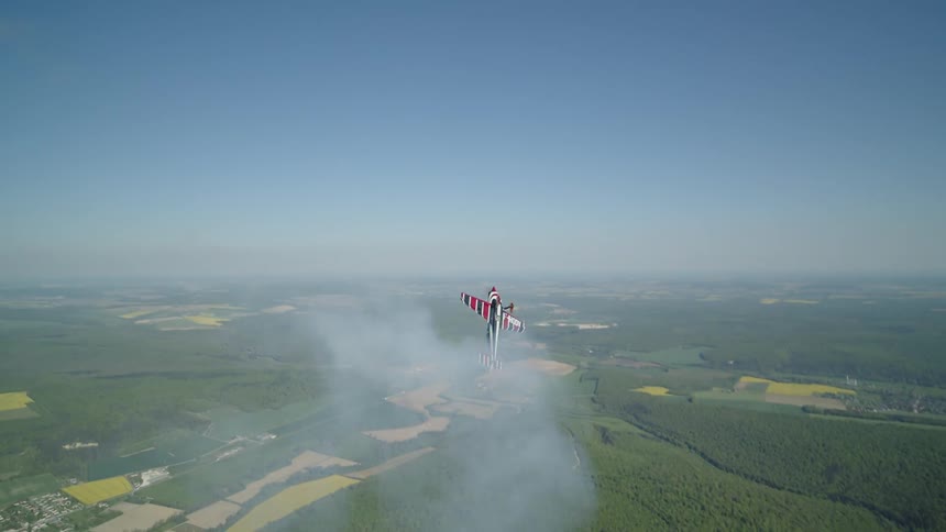 Singleengine plane performing radical maneuvers in the sky