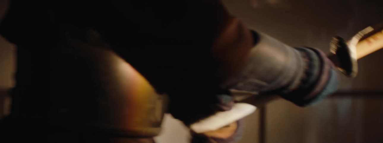 A sword fighter is holding a wooden sword