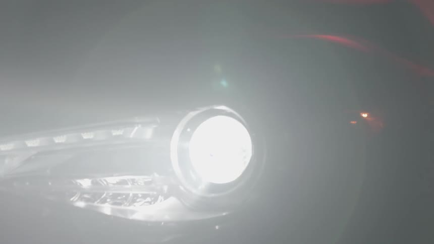 The headlights on a car flash on