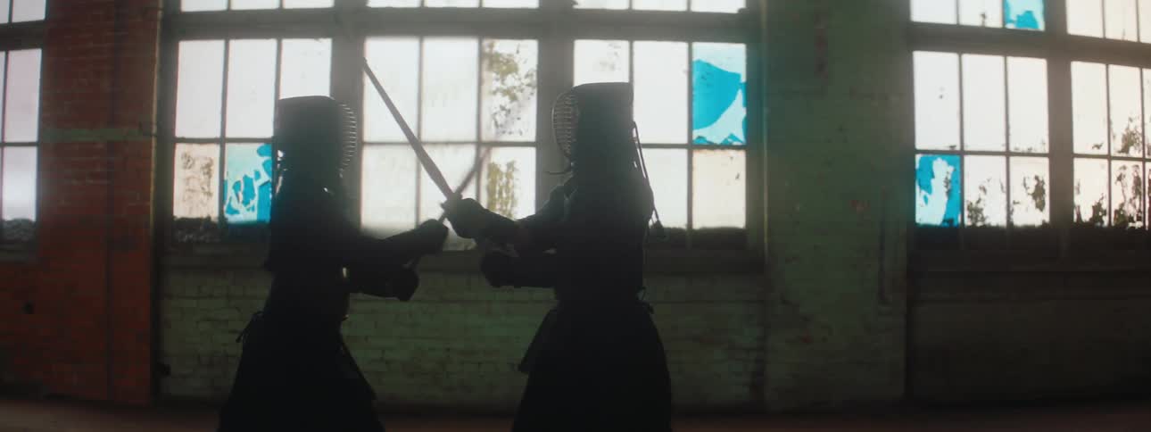 Two people are having a sword battle