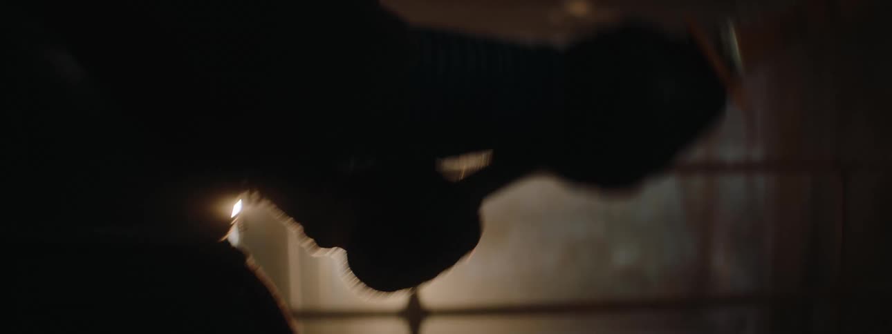 Kendo practitioners compete in a kendo match in an area lit by a spotlight