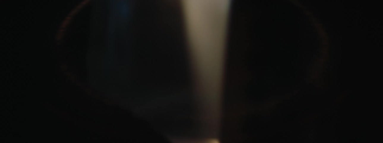 Light flashes on the woman hitting the drum