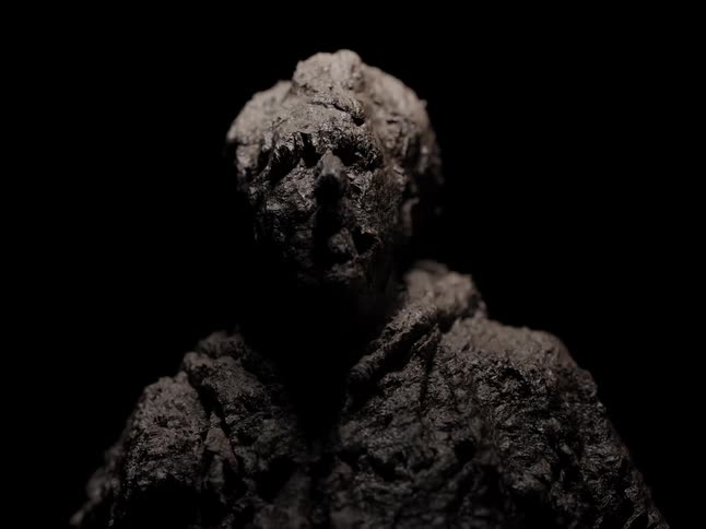 The black statue melts and transforms in the animation