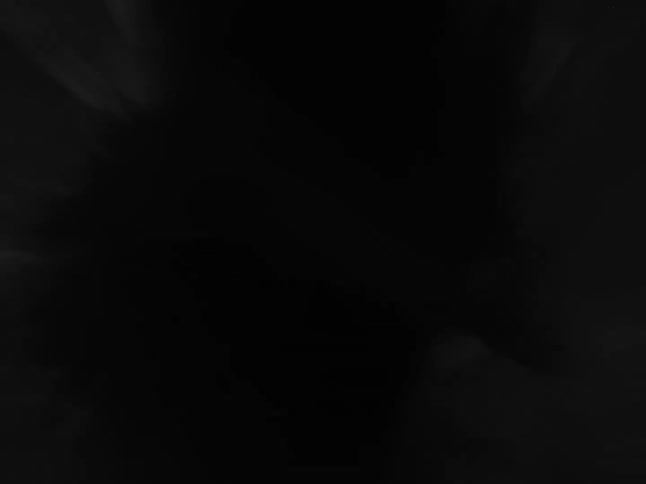 Dark smoke swirls upward in a chaotic spiral against a black background resembling an abstract vortex