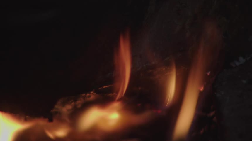A fire burns some wood