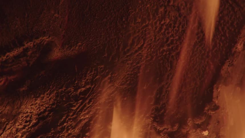 Fire burning beside a rock in the jungle