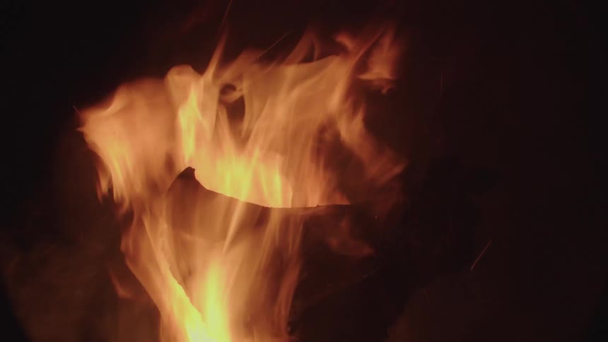 A fire burns bright at night