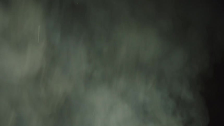 White smoke billowing against a black background