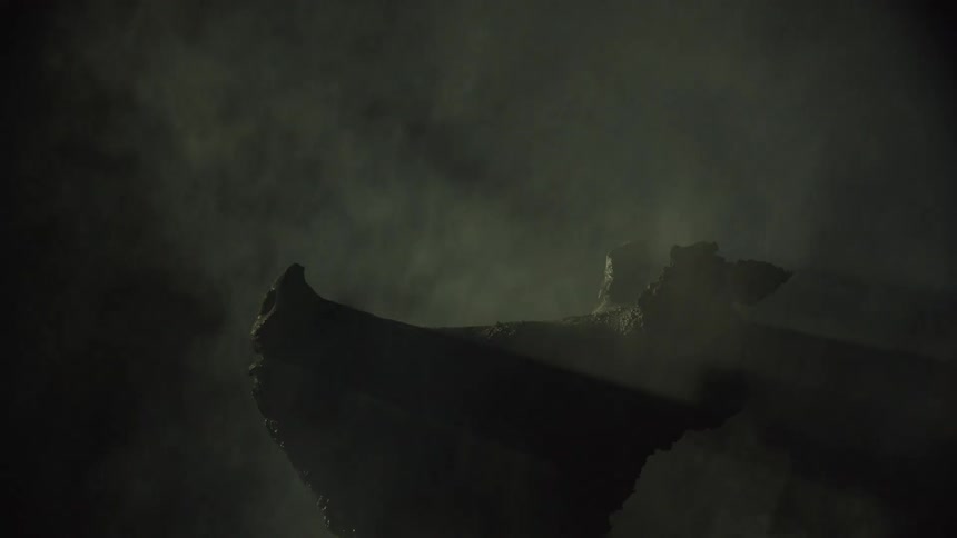 A burnt pigs head with charred jagged features emerges from dense smoke in a dark eerie setting