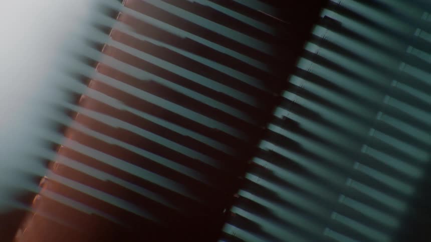 Rows of metal poles fall downwards