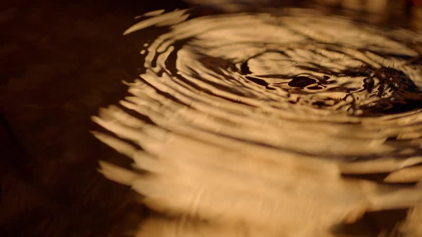 Water drops splashing into water