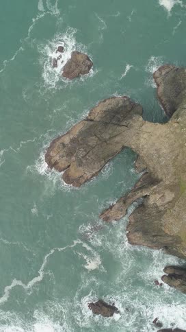 Waves crash along the rocks