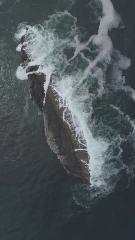 Waves crash against the rock