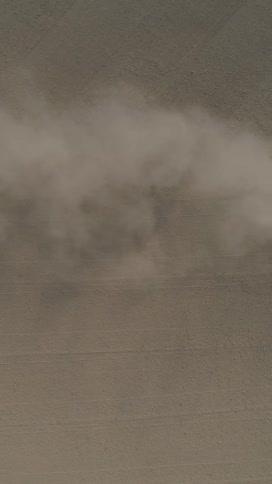 Aerial view of smoke rising from a desert environment