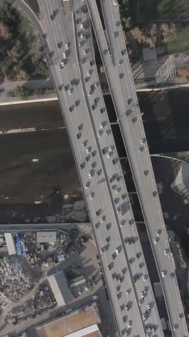 An aerial view of a busy highway with many cars passing over a canal