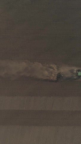 Aerial view of a combine harvester in an agricultural field