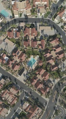 Urban neighborhood with tropical palm trees and swimming pools