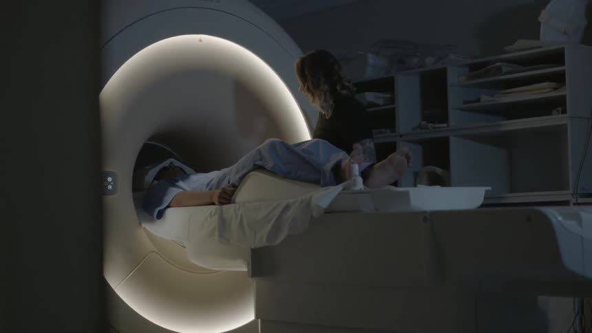A technician sends a person into an mri machine
