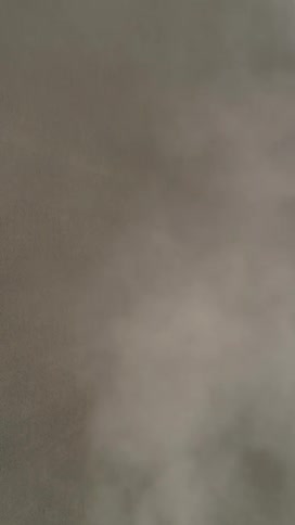 A dense cloud of smoke fills the scene obscuring the background