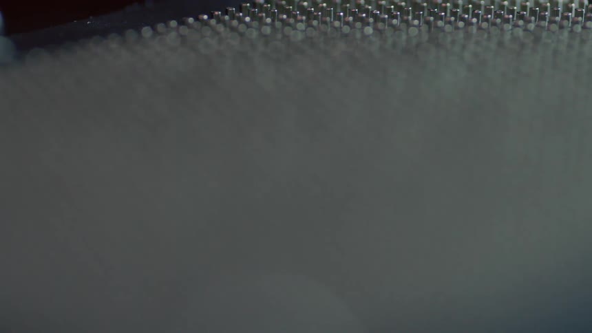Close up of many pins lined up in a row