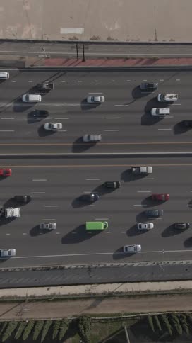 Aerial view of a busy multilane highway filled with cars and trucks