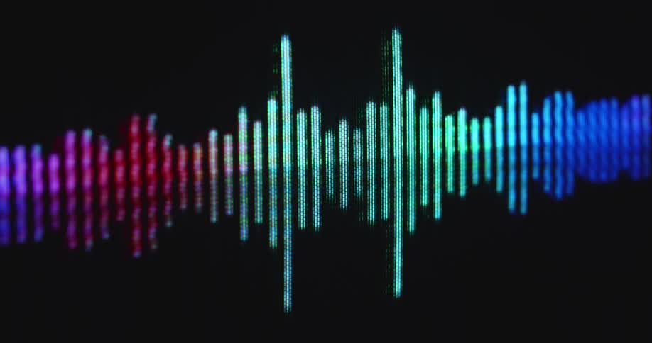 Dark RGB screen or pixelated computer display visualizing the sound of a voice or dance music with a colorful EQ animation moving in a dynamic way to the beat or loud audio signal