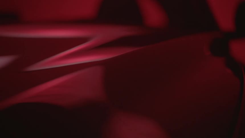 A crimson surface has bumps in it