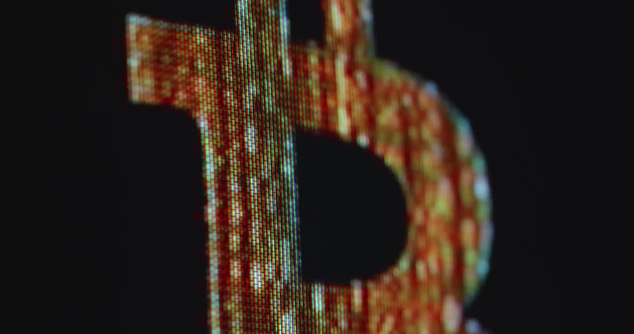 Macro close up of a pixelated tube tv screen displaying the letter B from the Bitcoin logo representing the digital currency and the monitory system of tomorrow based on a decentralised network and the blockchain