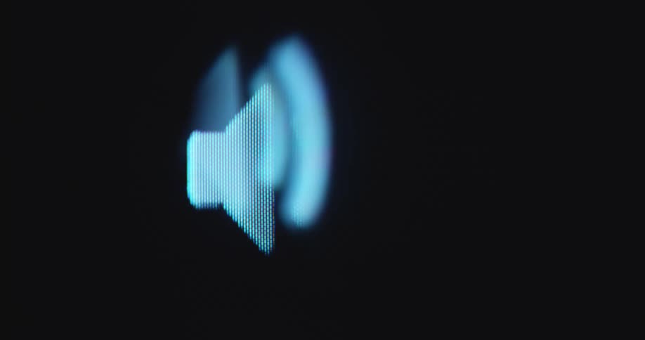 Macro close up shot of a pixelated screen displaying a sound icon or speaker emoji with appearing soundbars moving forward as symbol for the sound of a podcast or audio book being streamed on an online streaming platform