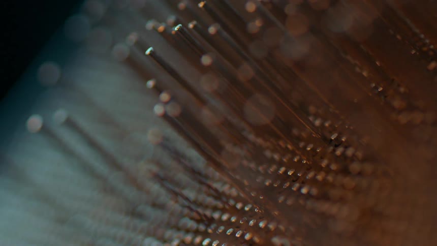 A large row of pins move around