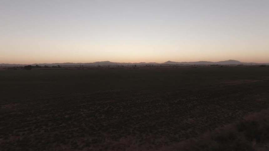 Aerial shot of an agricultural field at sunrise
