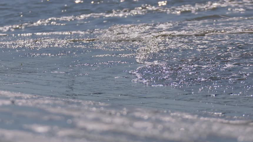 A wave is rolling onto a beach