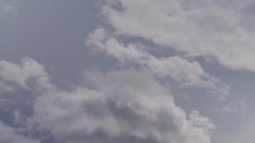 Time lapse of white clouds moving across the sky