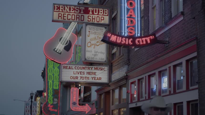 Neon signs line the side of buildings