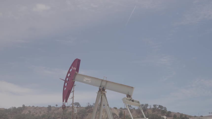 An oil rig hoists oil from the ground