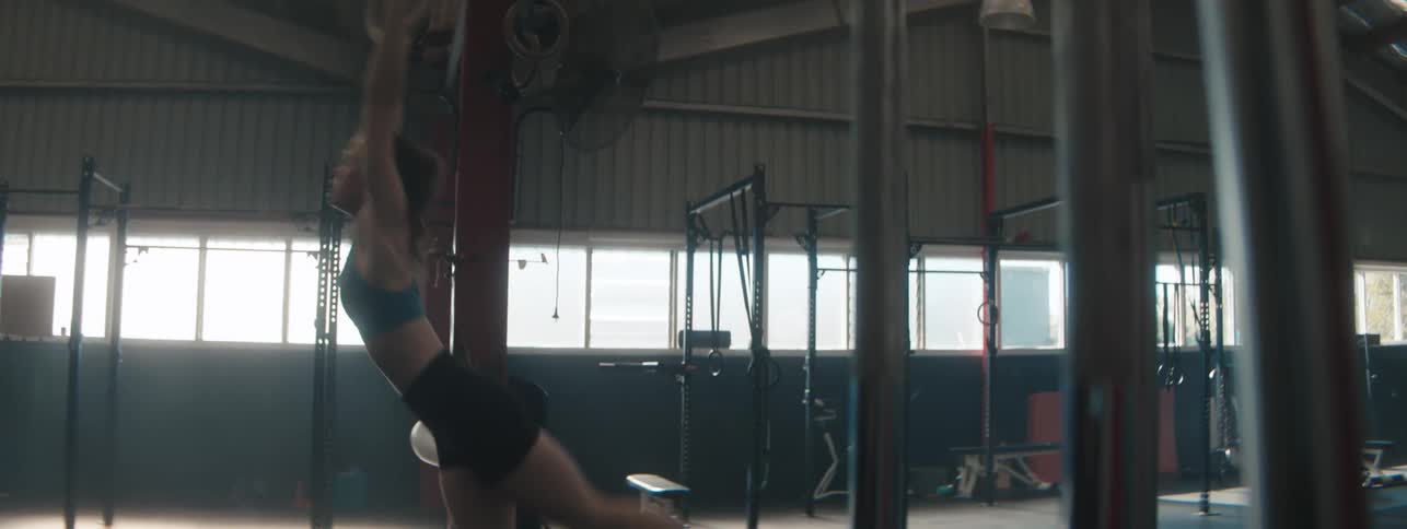 Woman in a gym doing training on rings