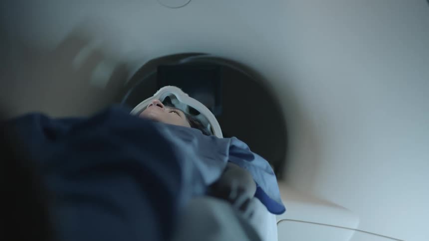 A patient enters an imaging machine in a hospital