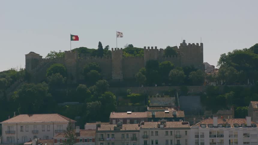 A bird flies above the castle ahead