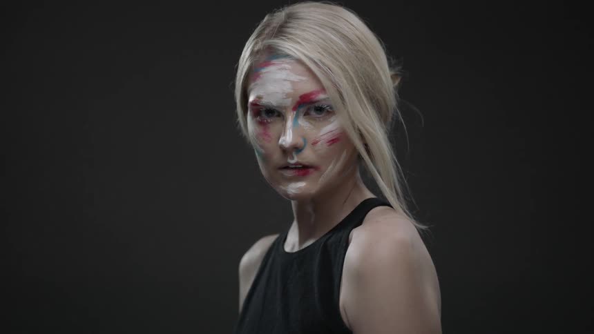 A woman with face paint poses