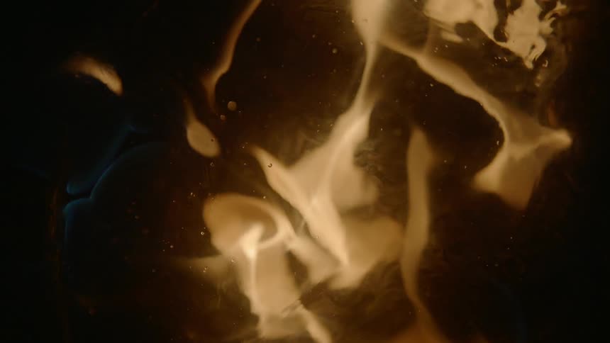 The fire flares near the liquid below