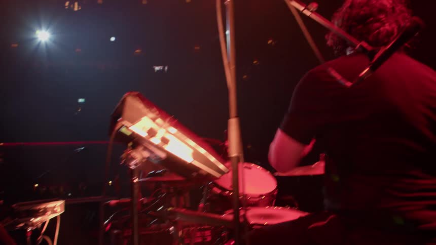 Musicians play for an audience during a rock concert