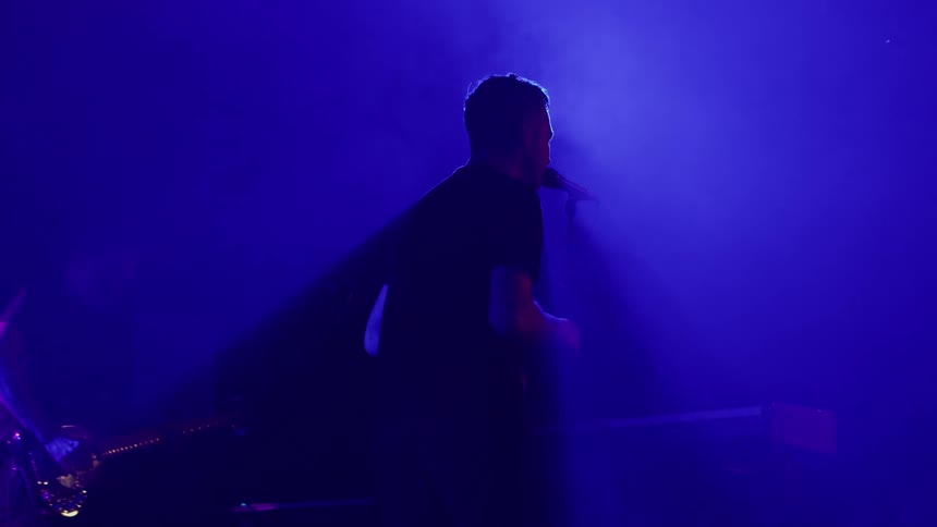 A man is playing the keyboard for the band