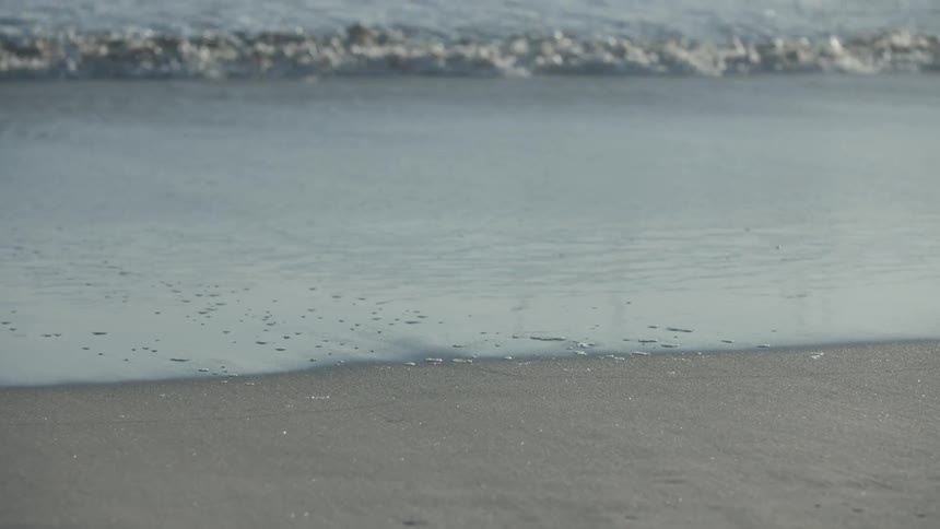 Waves crashing against the beach
