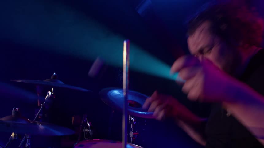 A man playing drums at a rock concert
